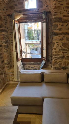a window in a stone walled room with a bench at Olympus in Olýmpoi
