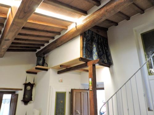 a staircase in a house with wooden beams at La Casa di Olga in Radicofani