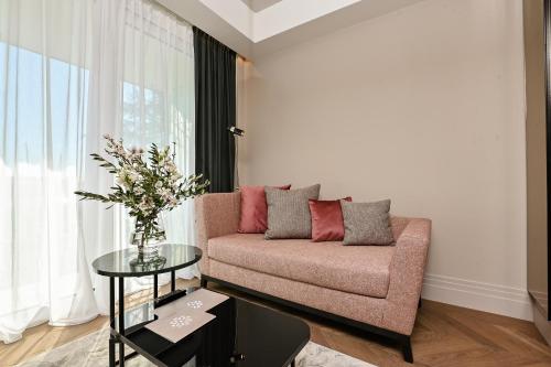 a living room with a couch and a table at Palazzo Rainis Hotel & Spa - Small Luxury Hotel - Adults Only in Novigrad Istria