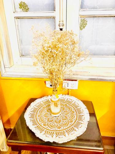 a vase with flowers on a table in a room at YoLoHome in Sa Pa