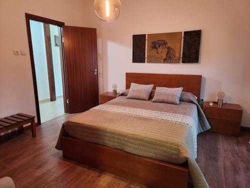 a bedroom with a large bed in a room at Casa da Avó Aninhas in Freixo de Espada à Cinta
