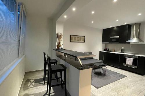 a kitchen with a bar with stools and a counter top at Welcome Beds in Bratislava