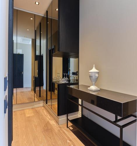 a room with black cabinets and a table with a vase at Palazzo Rainis Hotel & Spa - Small Luxury Hotel - Adults Only in Novigrad Istria