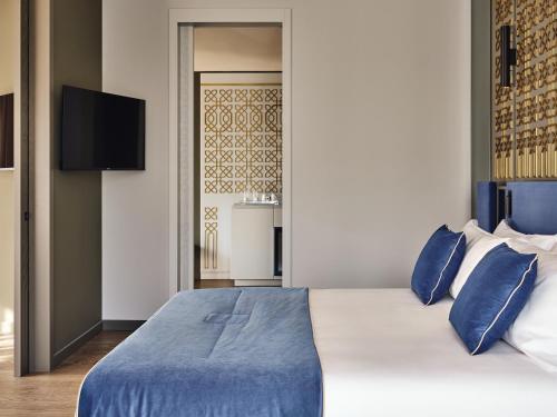 Postel nebo postele na pokoji v ubytování Boutique Hotel Stresa