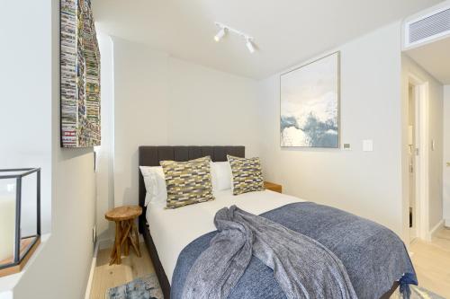 a bedroom with a bed with a blanket on it at Tokyo Studio with Balcony - Book 4 & Get 5th Night FREE in Cape Town