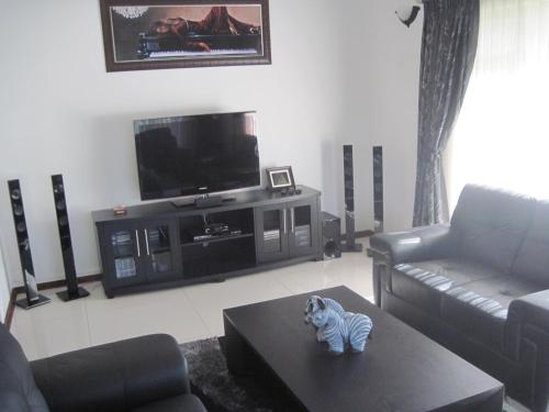 a living room with a zebra toy on a coffee table at Swallows Nest B&B in Margate
