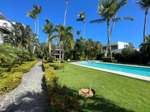 a resort with a swimming pool and palm trees at JARDIN SECRET B1 in Las Terrenas
