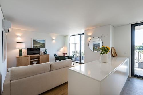 a living room with a couch and a table at BONFIM LIVING - Great location, al fresco dining and free private parking in Porto
