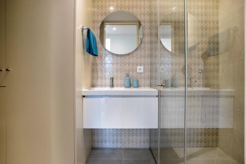 a bathroom with a sink and a glass shower at BONFIM LIVING - Great location, al fresco dining and free private parking in Porto