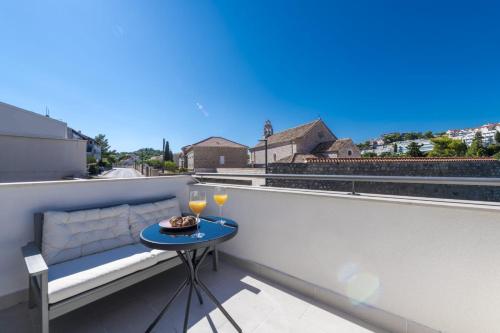 a small table on a balcony with a view at Apartment & Rooms Primi with FREE PARKING in Dubrovnik