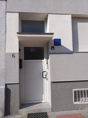 a white door in the side of a building at Apartman Bloom in Osijek