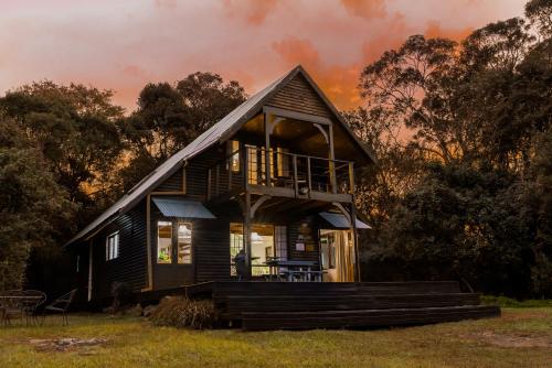 a small house with a gambrel roof at Rockwood Karkloof Forest Lodge & Mountain Cabin in Karkloof Nature Reserve