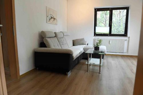 a living room with a couch and a table at Zum Wohlfühlen in Stadtnähe in Bad Neustadt an der Saale