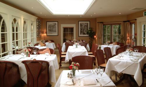 a restaurant with tables and chairs with white tablecloths at The Royal Hotel in Comrie