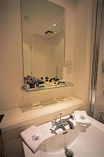 a bathroom with a sink and a mirror at The Royal Hotel in Comrie