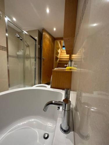 a bathroom with a sink and a bath tub at Cozy 2 bed flat ! Amazing bath! in London