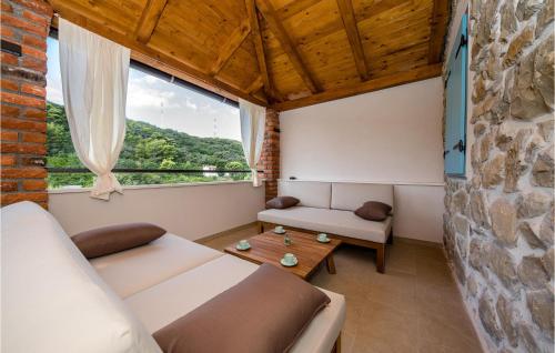 a living room with a couch and a table at 4 Bedroom Beautiful Home In Mundanije in Mundanije