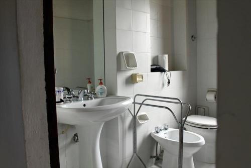 a white bathroom with a sink and a toilet at Maridiana Alpaca Country House in Umbertide