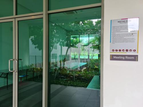 an entrance to a meeting room with glass doors at The Oasis KLCC View by SM Retreats in Cyberjaya