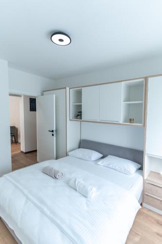 a bedroom with a large white bed with white pillows at Apartman Krželj B4 in Livno