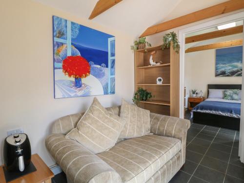 a living room with a couch and a bed at Ouzi's Place in Loughborough