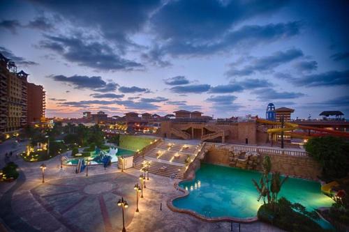 a view of a pool at a resort at night at porto marina north coast alamein in El Alamein