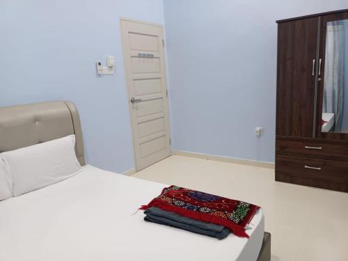 a bedroom with a bed with a dresser and a mirror at SERI IBAI DAMAI in Kuala Terengganu