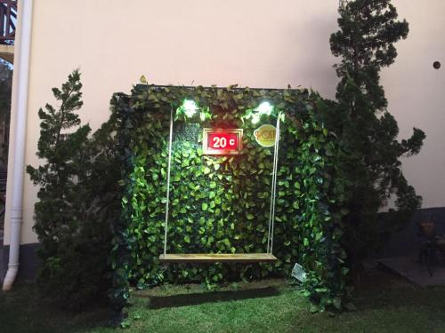 a door covered in ivy with a sign on it at Pousada Condado Brasileiro in Campos do Jordão