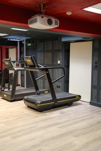 a gym with several treadmills in a room at Best Western Premier Santa Maria in LʼÎle-Rousse