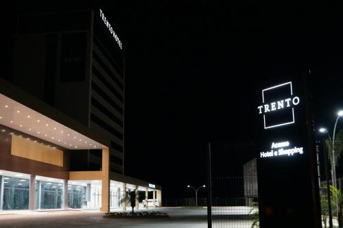 a taito sign in front of a building at night at Trento Hotel Guaíra by Unna in Guaíra