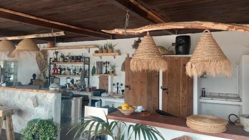 a kitchen with straw baskets hanging from the ceiling at la torre boutique rooms in Procida