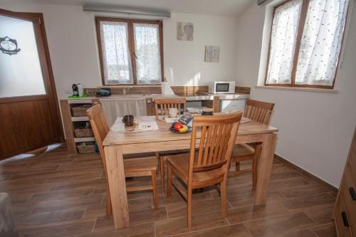a dining room with a wooden table and chairs at Agriturismo L'Istrice di Giò in Montalto di Castro