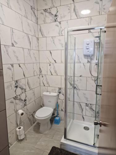 a bathroom with a toilet and a glass shower at 31 London Road Liverpool Studio Sleeps 4 in Liverpool