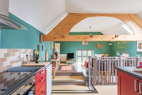 a kitchen with green walls and a vaulted ceiling at Nine Ladies in Matlock