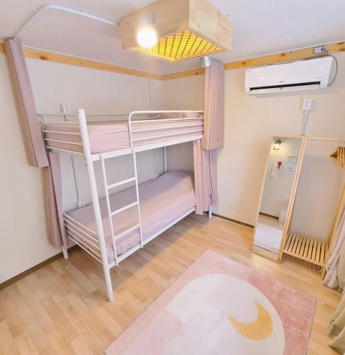 a bunk bed in a room with a ladder at Batwo Stay - For foreigners only in Seoul