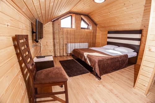 a bedroom with a bed and a tv in a room at Готель Чарда in Bukovel