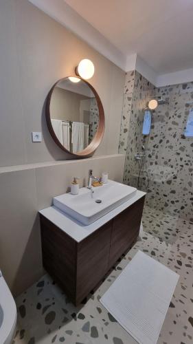 a bathroom with a sink and a mirror at Delta House - Beta apartment in Zadar