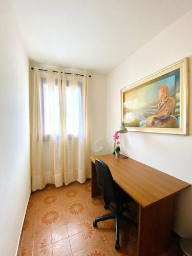 an office with a desk and a painting on the wall at HOME - Alessandra Holiday House in Piove di Sacco