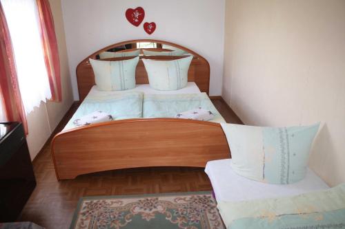 a bedroom with a wooden bed with pillows at zz_Lokschuppen Pasewalk-Erlebnisübernachtung im Schlafwagen in Pasewalk