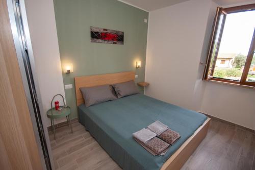 a small bedroom with a bed and a window at Agriturismo L'Istrice di Giò in Montalto di Castro