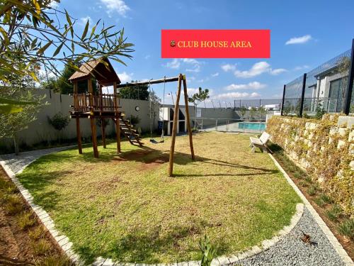 a playground with a swing set in a yard at Dubai 2 in Midrand