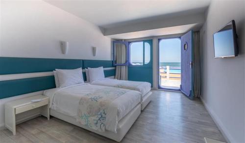 sypialnia z dużym łóżkiem i dużym oknem w obiekcie hotel tropicana w mieście Casablanca