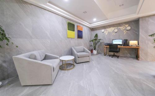 a living room with two chairs and a desk at Browndot Hotel Gwangju Pungam in Gwangju