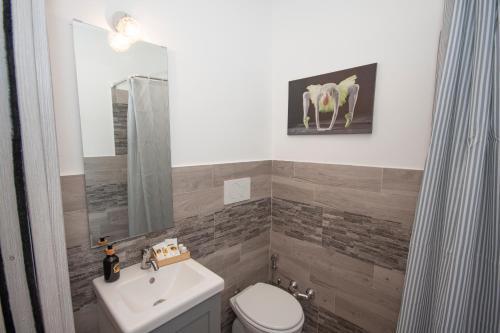 a bathroom with a white toilet and a sink at Agriturismo L'Istrice di Giò in Montalto di Castro