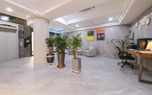 an office lobby with potted plants and a desk at Browndot Hotel Gwangju Pungam in Gwangju
