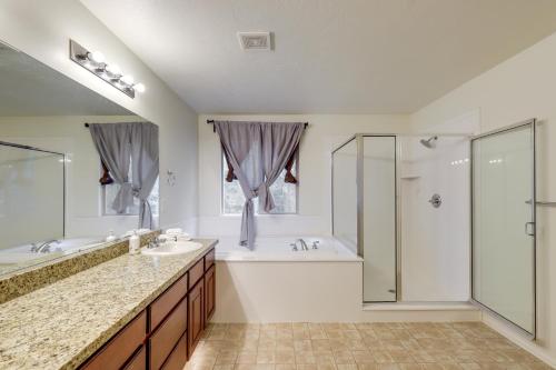 a bathroom with a tub and a sink and a shower at Spacious Vacation Rental Near Utah Lake! in Lehi