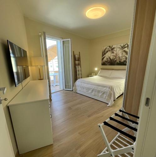 a bedroom with a bed and a sliding glass door at B&B CIVICO CINQUE in Pianella