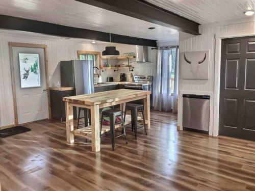 a kitchen with a wooden table and some chairs at Chez Dorance in Saint-Gabriel