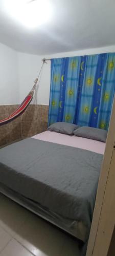 a bed with a blue canopy in a room at Encantadora casa con ambiente guajiro #3 in Barranquilla
