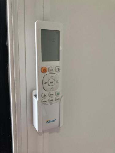 a remote control is attached to a wall at Modern GuestHouse Ironbound Newark with KITCHEN-FastTrainToNYC-OneStopToAirport in Newark
